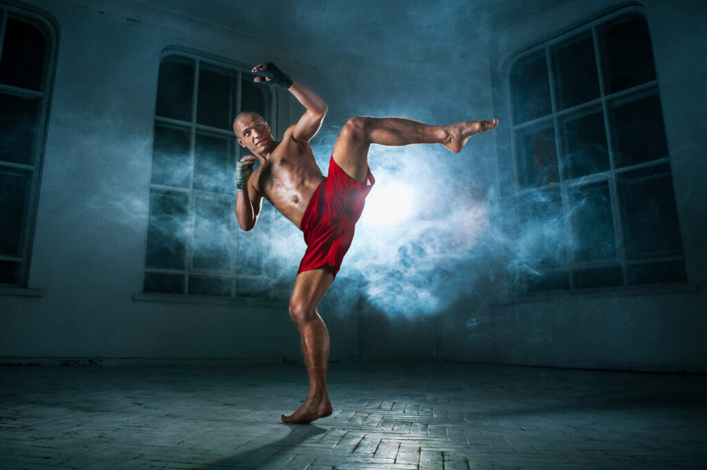 the-young-man-kickboxing-in-blue-smoke